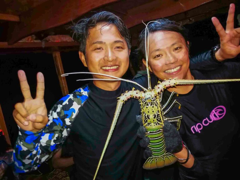 兩人手持大型龍蝦合影
